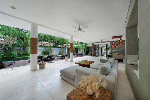 a living room with a couch and a table at The Muse Luxury Eco-Living in Munggu