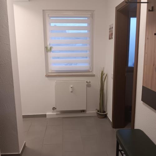 a white room with a window and a radiator at Ferienwohnung Grünes Leben in Simmerath