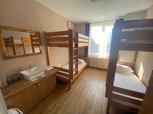 a bathroom with a sink and a bunk bed at Hostel Ferihegy in Vecsés