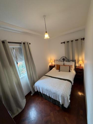 a bedroom with a bed and a window at Casa da Torre in Porto Moniz