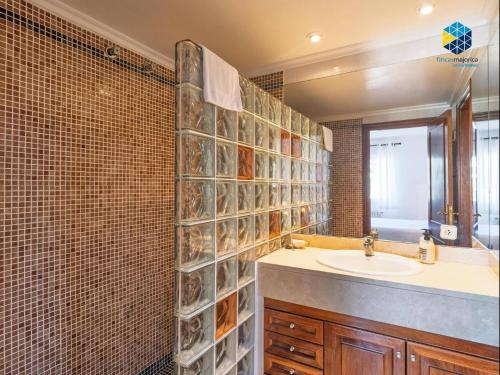 a bathroom with a sink and a mirror at Can Moragues and Martorell in Badia Blava