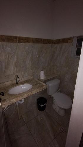 a bathroom with a sink and a toilet at Chacrinha in Campinas