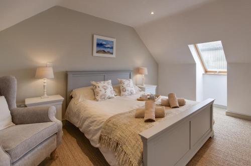 a bedroom with a large bed and a chair at 1 Bed in Swannington oc-2206 in Attlebridge