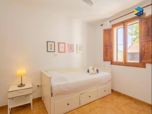 a bedroom with a bed with a teddy bear on it at Ca sa comare in Llucmajor