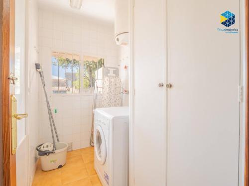 a white laundry room with a washer and dryer at Ca sa comare in Llucmajor