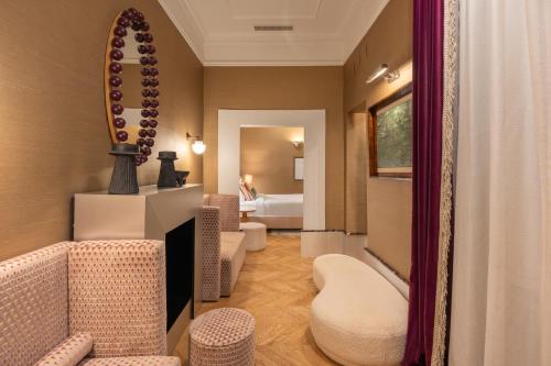 a hotel room with a mirror and a bathroom at The Couper Umiltà in Rome