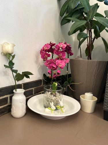 a table with a plate with pink flowers on it at Apartmány PARK in Klášterec nad Ohří