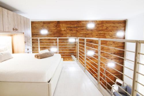 a bedroom with two beds and a wall of wood at Alessia's Flat - Portello in Milan