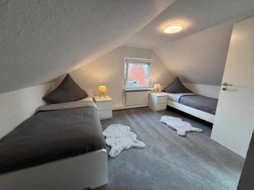 a bedroom with two beds and a window at Ferienhaus Teenös in Hinte
