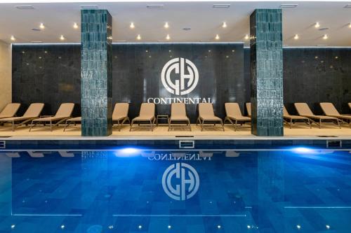 a conference room with a pool and chairs at Continental SPA in Bukovel