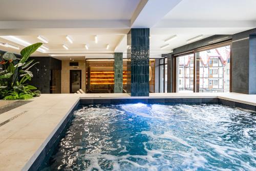 a swimming pool in the middle of a building at Continental SPA in Bukovel