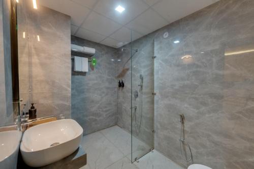 a bathroom with a shower and a toilet and a sink at Click Collection Ayodhya in Ayodhya