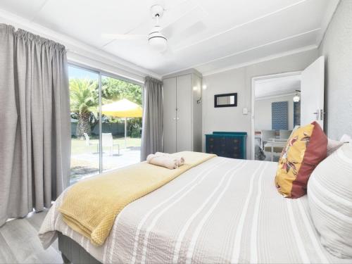 a bedroom with a large bed and a large window at 32 Main Road in Struisbaai