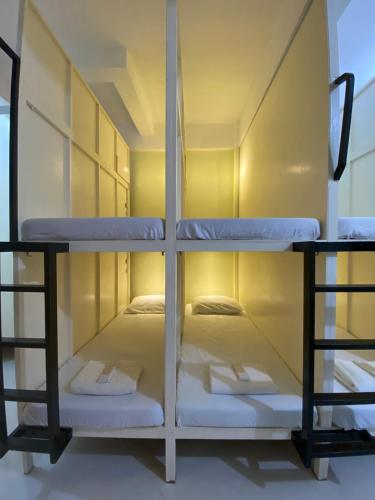 a room with two bunk beds in it at B2 Capsule Sleep Pods in Guiuan