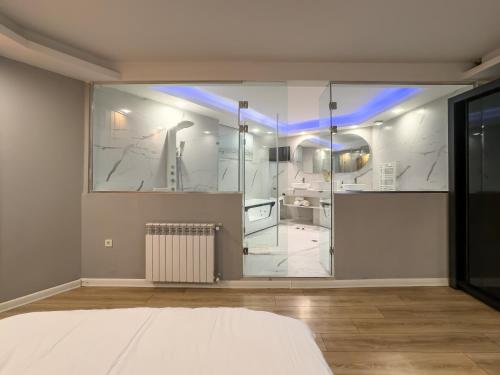 a large white room with a glass wall at Amelia Terrace Escape in Tbilisi City