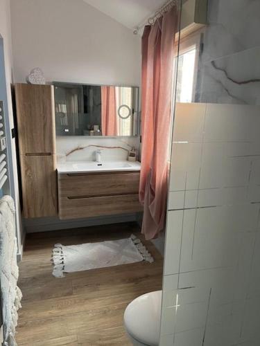 a bathroom with a tub and a sink and a toilet at chez Jess chambre d'hôte a UZES in Uzès