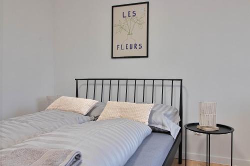 two beds with pillows and a picture on the wall at Moskovska with Public Parking in Banská Bystrica
