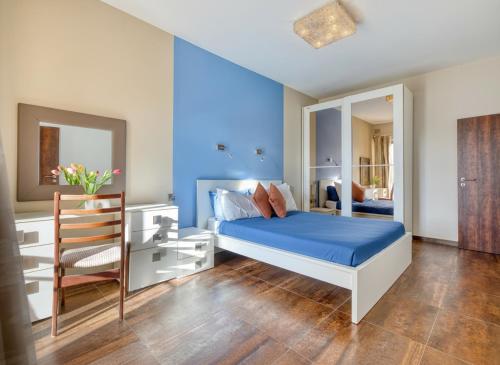 a blue bedroom with a bed and a mirror at Stunning 3BR breathtaking views outdoor dining in Rabat