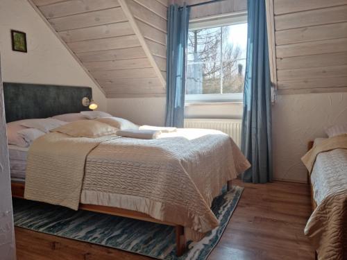 a bedroom with a large bed and a window at Koziołkowo in Bartoszylas