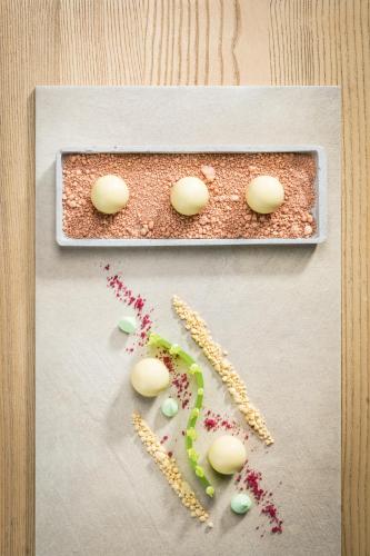 two plates of food with eggs and seeds on a table at Minglers Sportalm - Das Gourmet- und Genießerhotel in Kirchberg in Tirol
