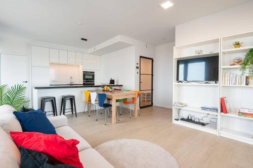a living room with a couch and a table at Perfectly situated condo with amazing views in Ostend