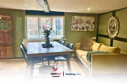 a living room with a table and a couch at 2BDR Cottage By Guest Nest Management In Horsham With Free Parking in Horsham