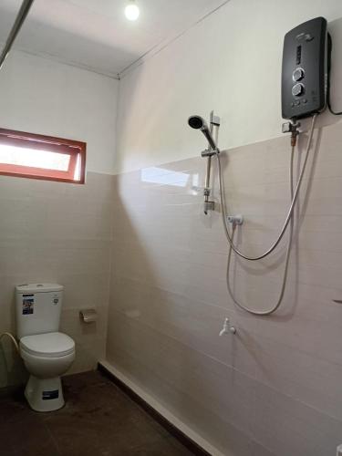 a bathroom with a shower and a toilet in a room at Browns Hill Villa - Ella in Ella