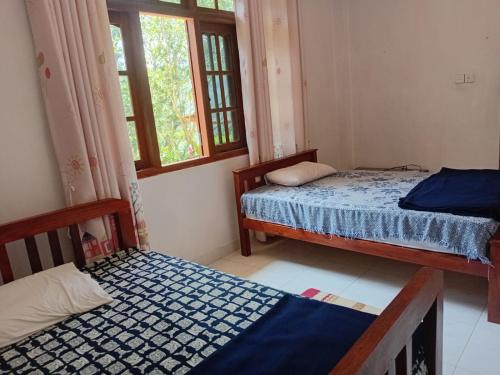 a bedroom with two beds and a window at Browns Hill Villa - Ella in Ella