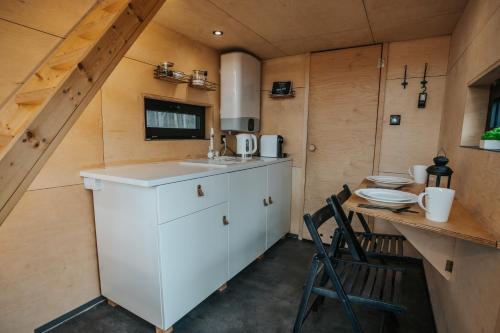 a kitchen with a sink and a table in a room at Domek na drzewie Ceprowo in Szczyrk