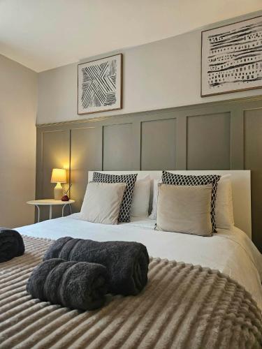 a bedroom with a large bed with pillows on it at Cosy Bungalow in the Peak in Glossop