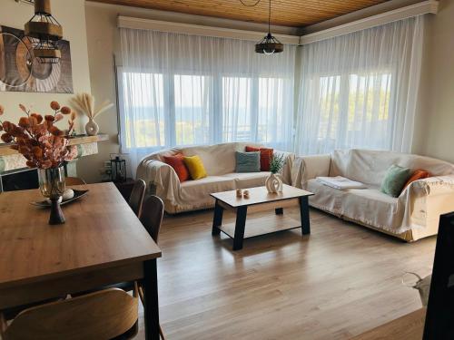 a living room with a couch and a table at Elaia Horizon Makri in Alexandroupoli