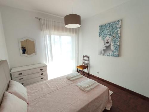 a bedroom with a bed and a window at Casa Santos Faro Beach in FAO