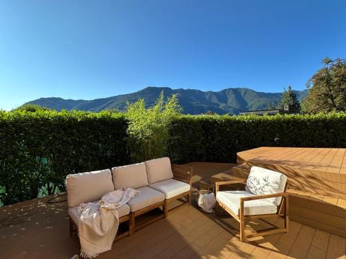 a couch and two chairs sitting on a patio at LA CALETTA SUITE APARTMENT- Panoramic Shared Pool, Secured Parking, Water Activities in Blevio