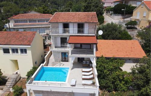 an aerial view of a house with a swimming pool at Holiday Home Brna V in Brna