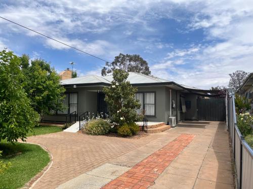 a house with a fence and a brick driveway at Family home central to everything in Mildura