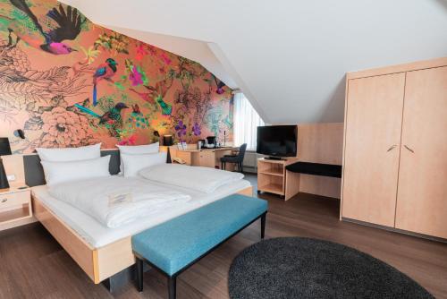 a bedroom with a bed and a wall with a mural at Parkhotel Bad Homburg in Bad Homburg vor der Höhe