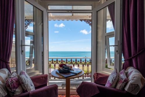 a room with a view of the ocean from a balcony at The Clifton in Shanklin