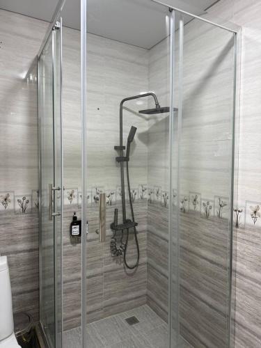 a shower with a glass door in a bathroom at Hotel Khiva Palace in Khiva