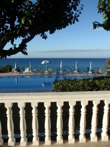 a view of the ocean from the balcony of a resort at Loukas Apartments On The Waves in Tragaki