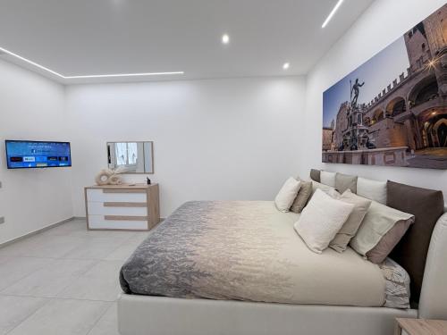 a bedroom with a bed and a painting on the wall at Dream Suite Bologna in Bologna
