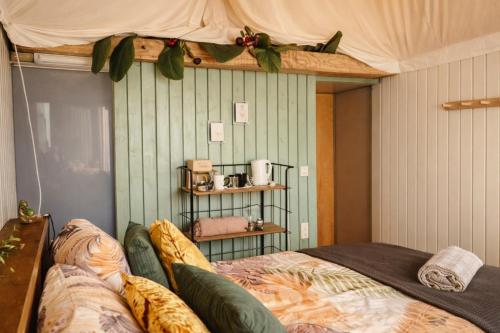 a bedroom with a bed and a shelf on the wall at Luxury Suite in Heerewaarden