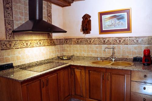a kitchen with two sinks and a stove at Finca Vitoria in Moratalla
