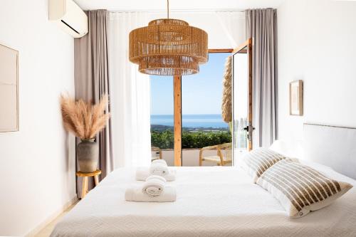 a bedroom with a bed with a view of the ocean at Finca Sol y Cielo in Cajís