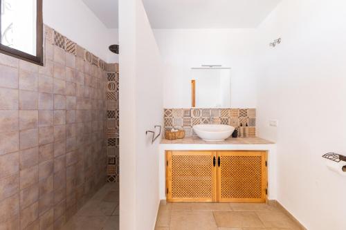 a bathroom with a sink and a mirror at Finca Sol y Cielo in Cajís