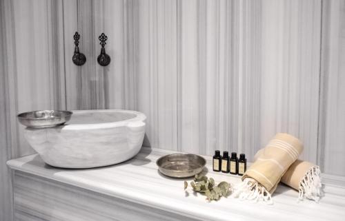 a white bathroom with a bowl on a table at Me by Mula in Istanbul