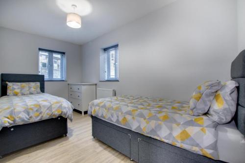 a bedroom with two beds and a dresser at 5 Bed in Bala oc-bow163 in Bala