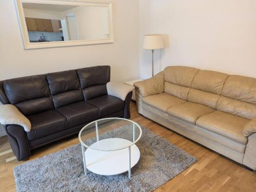 a living room with a couch and a coffee table at A charming countryside accommodation near Malm in Oxie