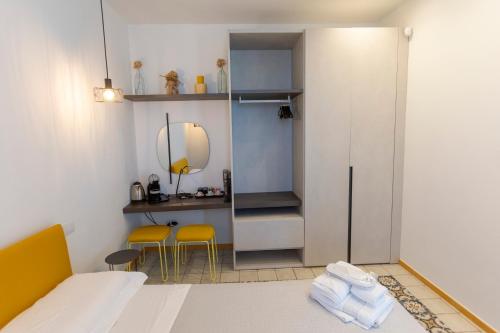 a small room with a bed and a mirror at La Dimora dei WaLori in Bisceglie