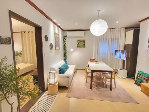a living room with a table and a couch at 대구 K Stay in Daegu