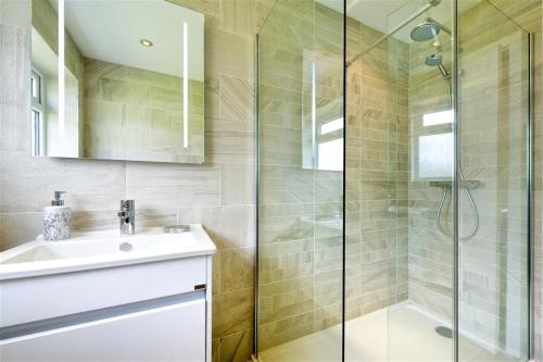 a bathroom with a sink and a shower at 2 Bed in Pwllheli oc-45caed in Abersoch